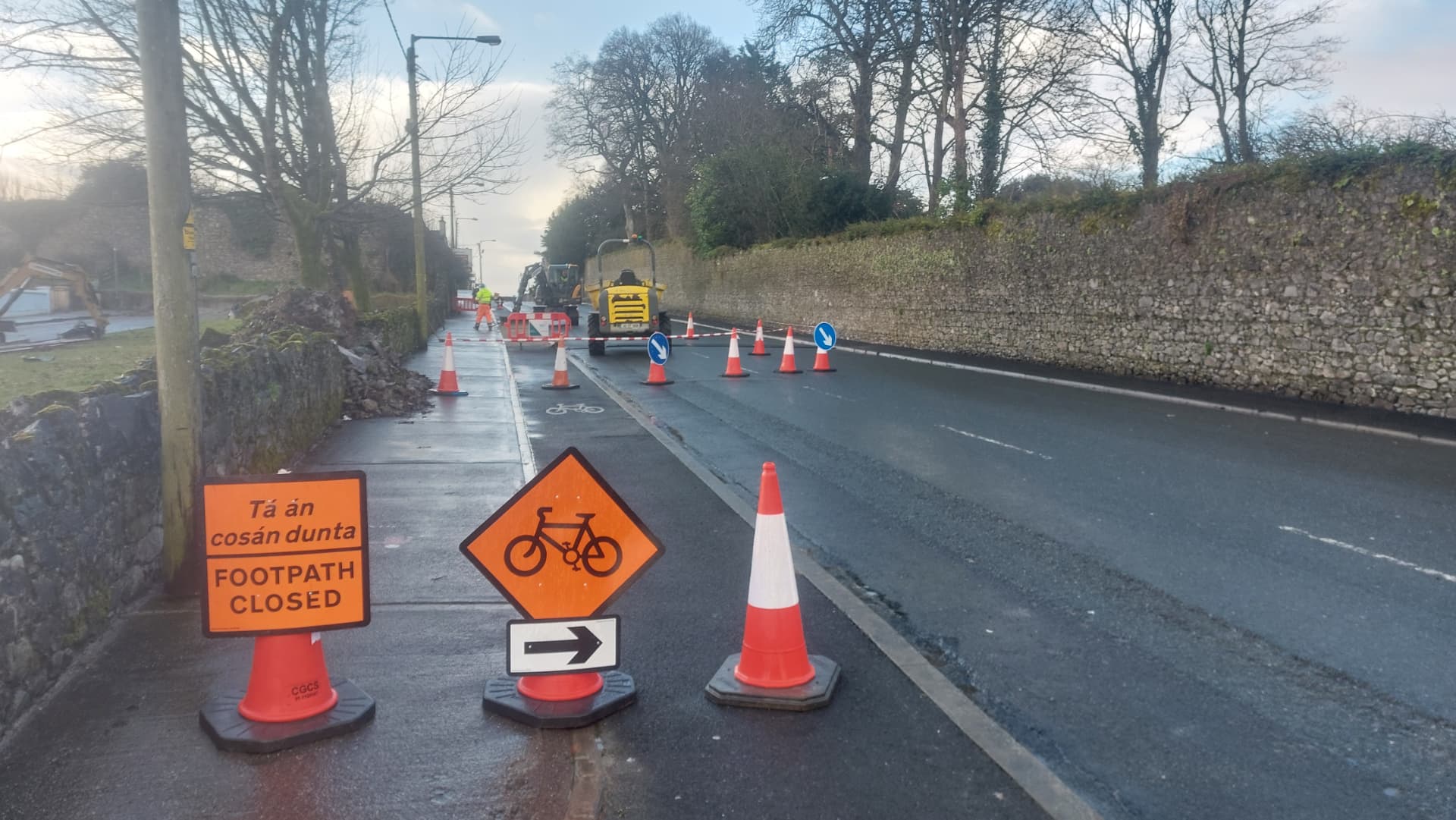 Roller compacting freshly laid road surfacing