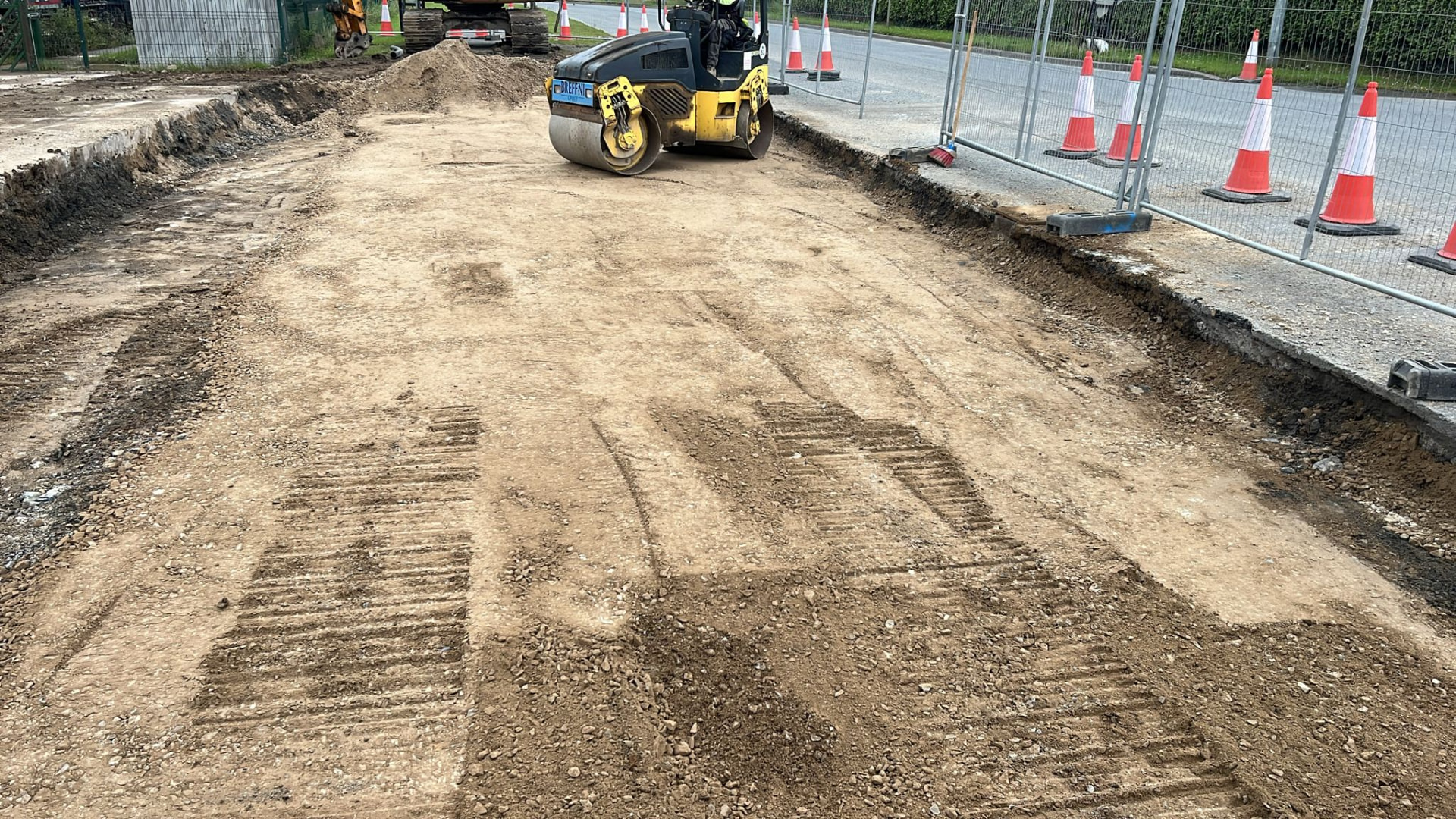 Roller compacting a prepared sub-base